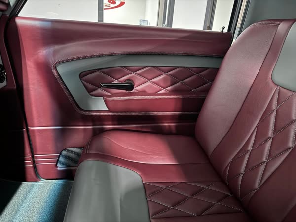 Maroon diamond-stitched leather door panel in a 1967 Chevrolet C10